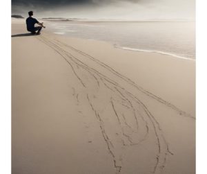 Person on beach drawing line in sand to Master Emotional Control