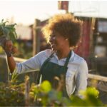 A woman gardening in the sunlight, engaging in an activity that boosts Vitamin D levels, as recommended in 'The Sunshine Vitamin: 20 Ways to Boost Your D Levels Naturally' article.