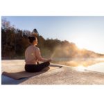 Woman practicing outdoor yoga in the sunshine, a natural way to increase Vitamin D, as suggested in 'The Sunshine Vitamin: 20 Ways to Boost Your D Levels Naturally'.