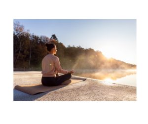 Woman practicing outdoor yoga in the sunshine, a natural way to increase Vitamin D, as suggested in 'The Sunshine Vitamin: 20 Ways to Boost Your D Levels Naturally'.