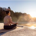Woman practicing outdoor yoga in the sunshine, a natural way to increase Vitamin D, as suggested in 'The Sunshine Vitamin: 20 Ways to Boost Your D Levels Naturally'.