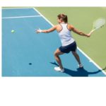 A person playing tennis on a sunny court, an active way to soak up Vitamin D as featured in 'The Sunshine Vitamin: 20 Ways to Boost Your D Levels Naturally'.