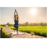 Serene Stretch: A woman in a peaceful setting practices a yoga pose, stretching towards the sky, embodying the harmony of mind and body through the art of yoga, enhancing flexibility and inner peace.