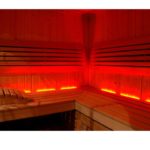 nfrared Sauna interior with visible infrared heaters mounted on the walls, showcasing the advanced and unique heating technology, set in a sleek and modern design.