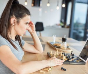 a women playing chess. 