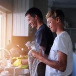 Time Hacks for Moms: A family working together on household chores or tasks, showing teamwork and shared responsibilities.