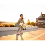 A person doing bodyweight exercises in a park, showcasing travel-friendly workouts to stay fit and mindful while traveling.