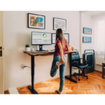 An adjustable standing desk in a workspace, helping to promote movement and comfort while transforming your home office environment.