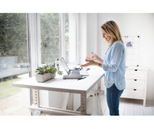 A modern standing desk setup in a home office, showcasing the benefits of transforming your home office for improved posture and wellness.