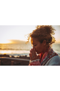 A woman with her hands covering part of her face, symbolizing contemplation and emotional balance through frequency therapy.