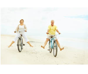 A couple happily riding bikes together, representing emotional balance, connection, and the joy of shared outdoor activities for well-being.