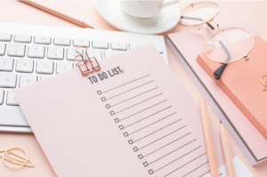 Neatly organized desk with a daily planner, a cup of coffee, and stylish office supplies, ready for a productive day. Real Self-Help for Everyday Life.