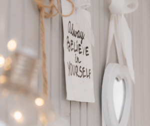 Rustic home decor featuring an inspirational quote ‘Always believe in yourself’ on a wooden plaque, enhancing a cozy, motivational living space. Real Self-Help for Everyday Life!