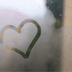 What I Hope You Feel If You're Reading This: A rain-speckled window, capturing the quiet ache of healing and missing someone deeply.