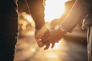 I Still Believe in Love: Two hands gently clasped together, representing human connection, comfort, and the reminder that you’re not alone.